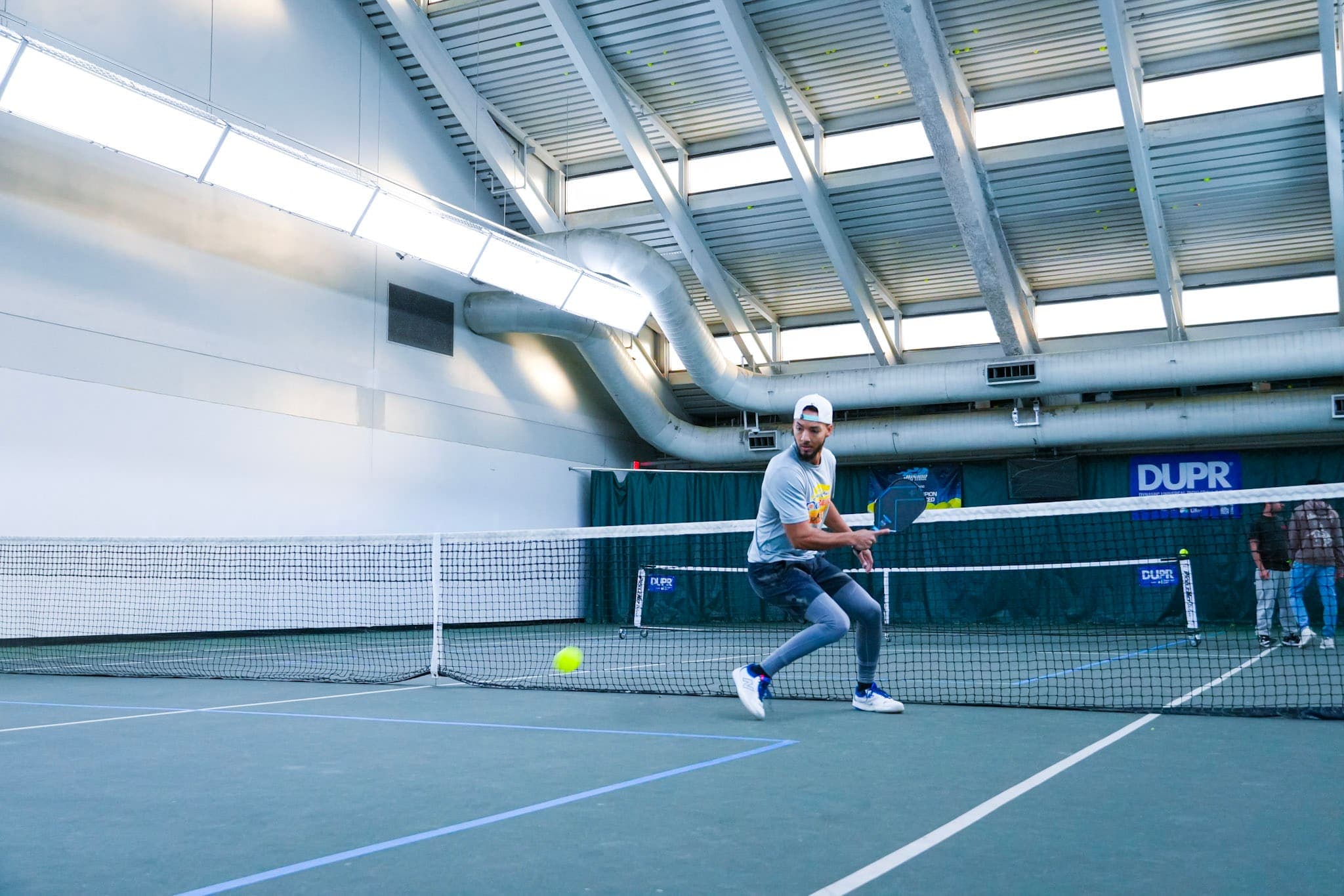 A CourtQuest player lunging for a shot mid-rally at the Chill N' Dill championship