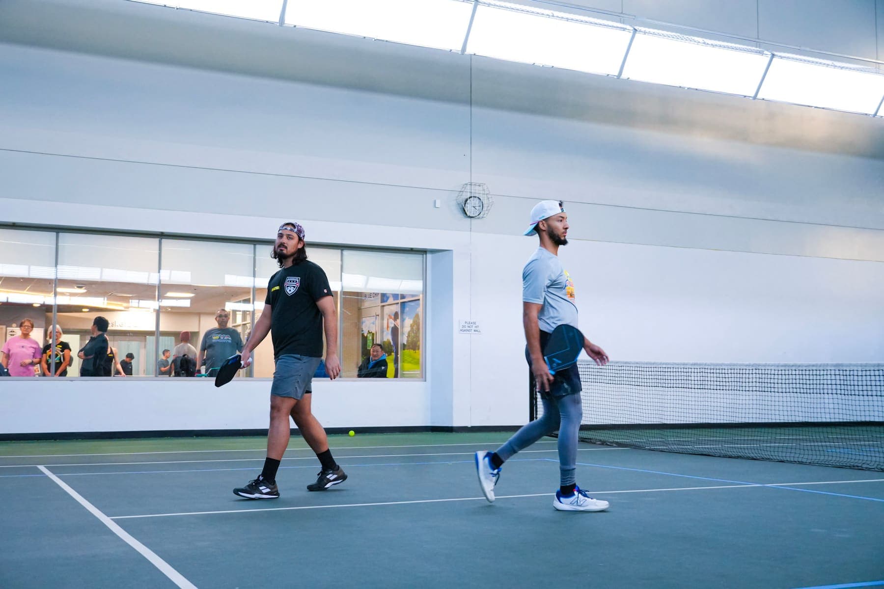 Two players walking off the court after a match