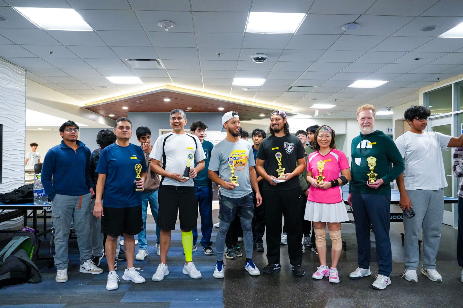 Winning teams holding trophies